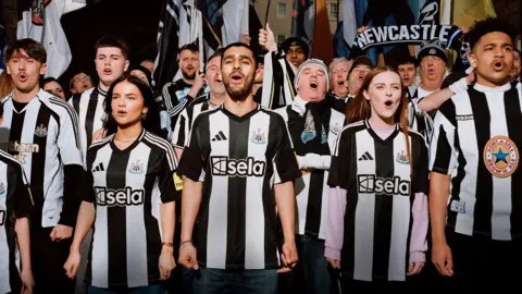 Adidas Fans wear Newcastle United's new home shirt alongside supporters decked out in previous Adidas jerseys