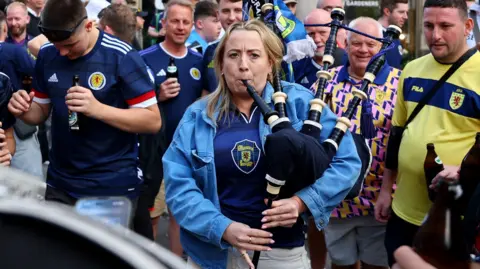 A woman playing bagpipes