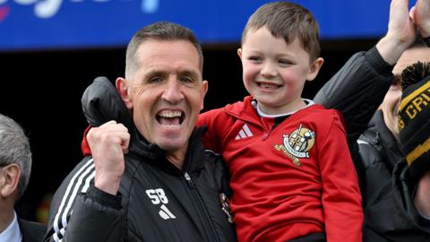Stephen Baxter celebrates the victory with a young fan at Seaview