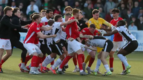 Lane and Glentoran players fight after final whistle