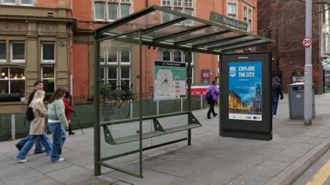 A bus stop in Nottingham city centre near the Victoria Centre in Milton Street complete with an advertising screen