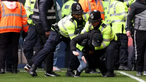 Reuters Police dealing with fans at West Brom v Wolves
