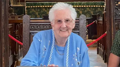 Lucille Terry smiling in a church