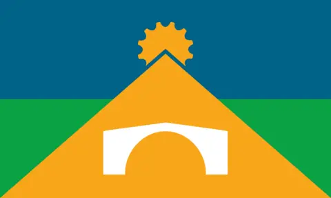 Telford & Wrekin Council A flag which features a yellow triangle with a white Ironbridge at its centre. There is also a yellow cog on top of the triangle. The background comprises a blue top half and a green bottom half.