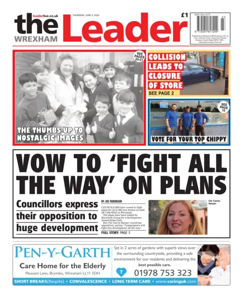 The Wrexham Leader The Wrexham Leader newspaper front page shows main headline next to a picture of a woman. Vow to 'fight all the way' on plans; Councillors express their opposition to huge developement. Other headlines on the front page are: Collision leads to closure of store,  thumbs up to some nostalgia and vote for your top chippy. There is an advert at the bottom for Pen-y-Garth care home.