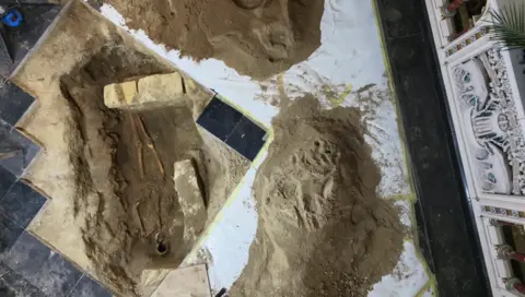 Stichting 6213HL A skeleton beneath tiles