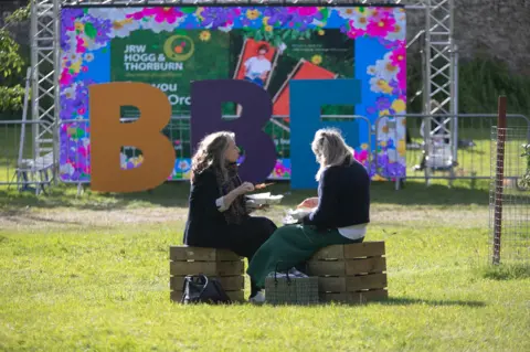 Borders Book Festival Two people sat in front of a sign saying BBF