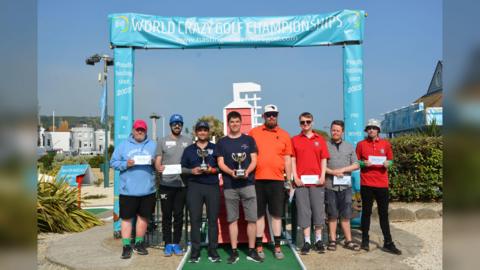 Competitors from the 2023 event with their trophies 