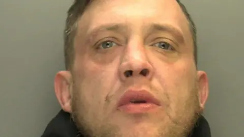 South Wales Police A police mugshot of Ashley Daley