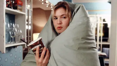 Laurie Sparham/Universal/Studio Canal/Miramax/Kobal/Shutterstock Renee Zellweger with a duvet over her head and a tub of Ben & Jerry's ice cream in her hand in Bridget Jones The Edge Of Reason in 2004