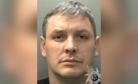 Gwent Police A photo of Ian Probert shows him looking at the camera. He has short hair flecked with grey, some facial hair and brown eyes. He is wearing a white T-shirt.