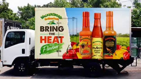 A lorry in Jamaica advertising hot sauces from local brand Walkerswood on the side of the vehicle