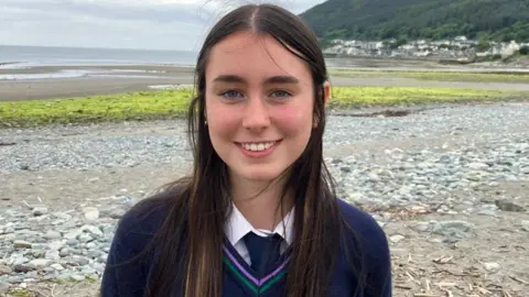 BBC a girl in Shimna College uniform, photographed on the beach at Newcastle