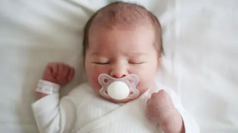 Getty Picture baby sleep with a large white dummy in his mouth.