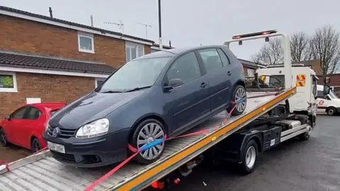 A car on a recovery truck