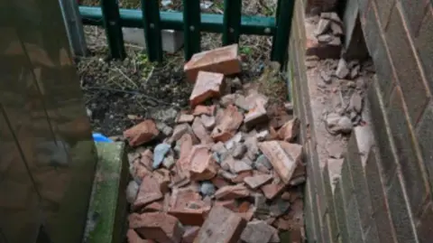 Nottinghamshire Police Bricks lying on the ground near hole in wall