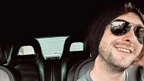 Geraint Vape Shop owner Geraint smiles in his car