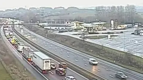 Slow moving traffic including several lorries in the foreground on the M61 north
