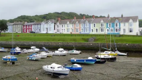 Roger Kidd | Geograph Aberaeron seafront with boats in the harbour and overlooked by a row of terraced homes painted in different colours