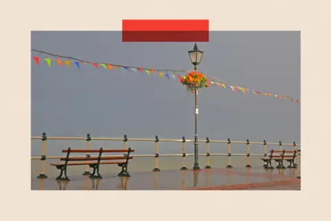 Getty Images A view of esplanade with bright flags and hanging baskets
