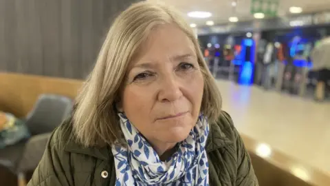 Janet Shreeve from Shreeve Care Services wearing a green jacket with a blue and white scarf