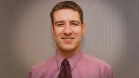 Scottish Police family photo with a smiling Alistair Wilson in pink shirt and tie