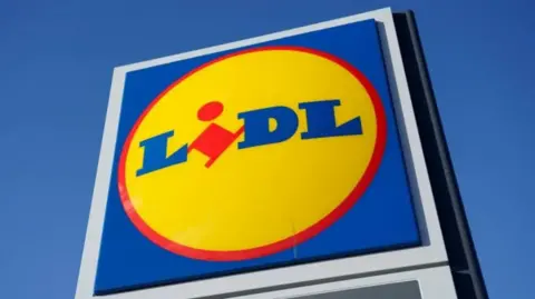 A large blue sign against a blue sign and there is a yellow circle in the middle of the sign with the word "lidl" written inside