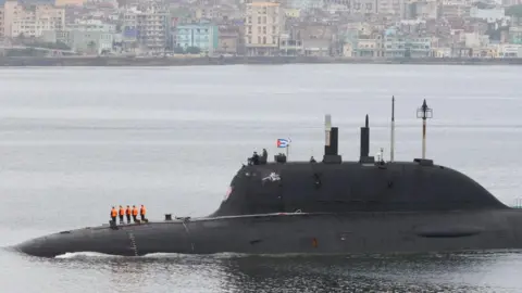 EPA A Russian submarine partly submerged in water