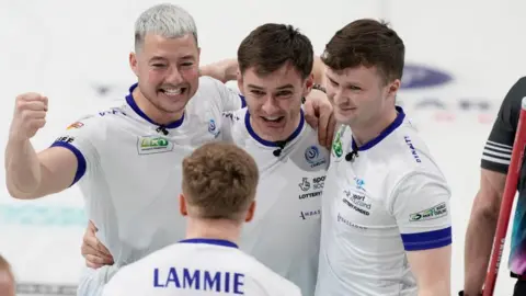 Reuters Scotland's Hammy McMillan celebrates with Bobby Lammie, Grant Hardie and Bruce Mouat after winning the semi final match against Canada in the World Men's Curling Championship