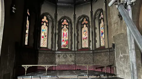 Shaun Whitmore/BBC One end of the St John the Baptist Church in Harleston. Soot is coating the walls of the church and there is scaffolding to support the building.