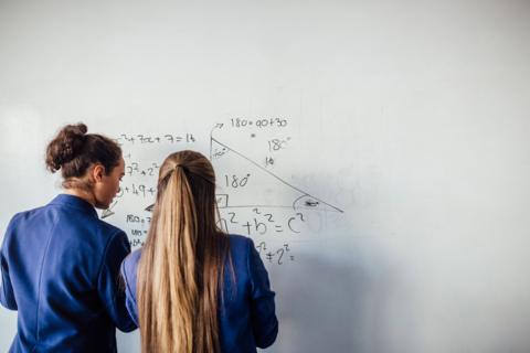Students doing maths on a whiteboard