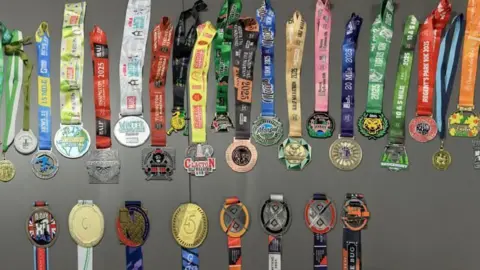 Stephan Couture two rows of colourful race medals are shown on display