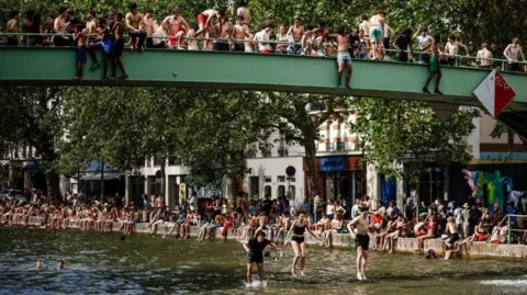 EPA people jump into a Paris canal to cool off