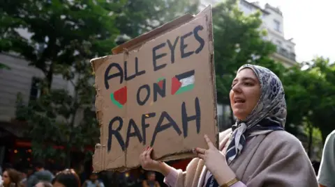 EPA A woman holds a sign saying 'All Eyes on Rafah' at a protest at the Sorbonne University in Paris