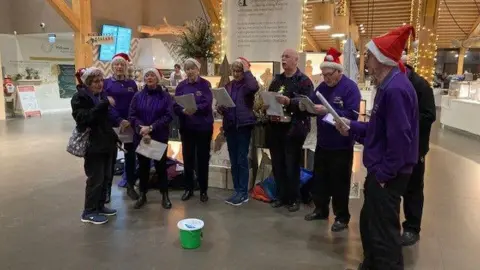 Choir greets travelers stopping at Gloucester Services