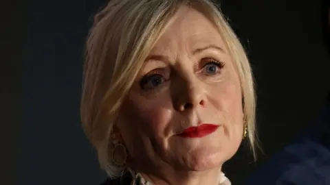 Reuters A head shot of Tracy Brabin. She has blonde, chin-length hair and red lipstick.