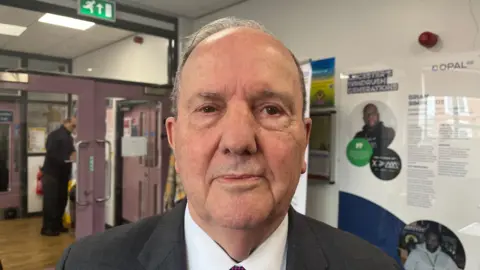 A man in a jacket and tie