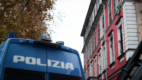 A blue Italian police van