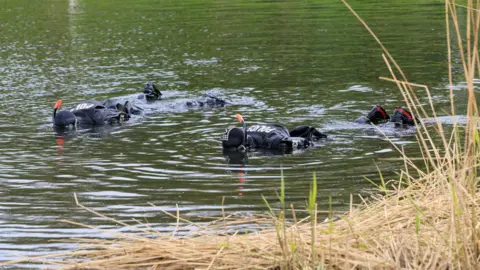 Police handout Police divers searching Blackleach Reservoir for Mr Everett's body