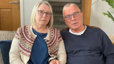 Image of Denise and Colin Turton sitting together on a sofa