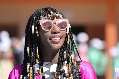 AFP via Getty Images Adama Amanda Ndiaye Aka Adama Paris, Senegalese designer and guest of French president visits the Bel Air college on February 2, 2018, in Dakar. 