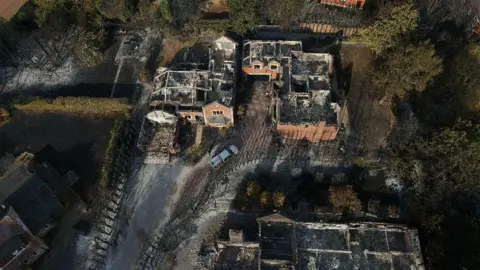 PA Media An aerial view of the remains of burnt out houses in the Quarry Park Road area of Stourbridge