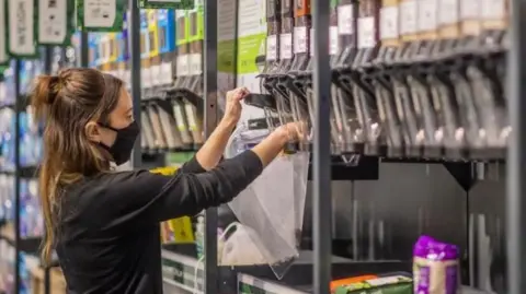 Getty Images A woman filling up a plastic bag