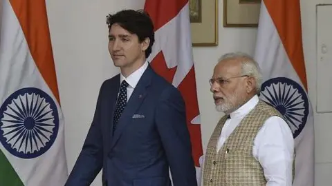 Canadian Prime Minister Justin Trudeau walks with PM Narendra Modi before a meeting at Hyderabad House on February 23, 2018