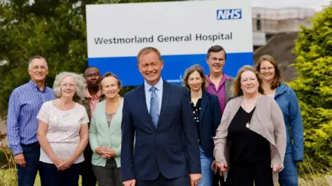 Handout Tim Farron alongside Liberal Democrat campaigners outside Westmorland General Hospital