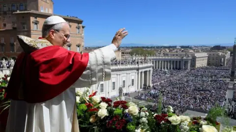 Pope Leo XIV waves from the main balcony of St. Peter's Basilica