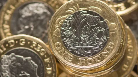 A pile of £1 coins.