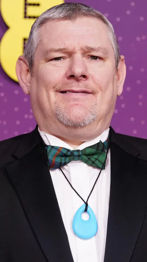 PA Media John Davidson with a tuxedo