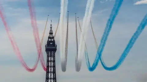 Red, white and blue vapour trails as the Red Arrows fly past Blackpool Tower