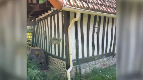 David Balfour A close-up of a black and white timbered building, which appears to be very old, in which the fork was found